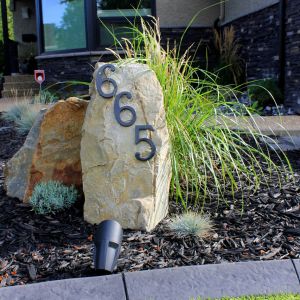 Residential landscaping with mulch and house number rock