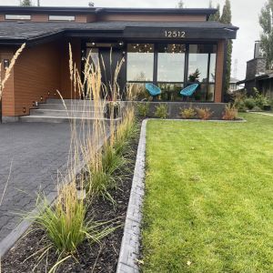 Residence with concrete curbing and paving stone driveway