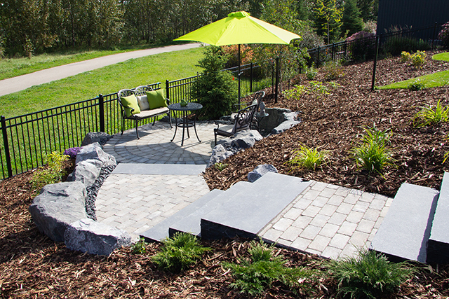 Stone steps, retaining walls and patio area