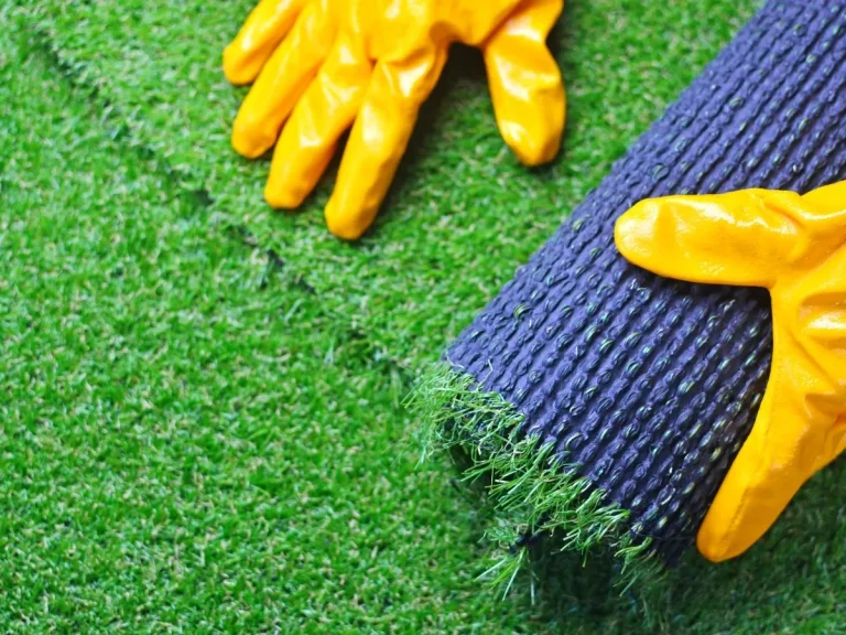 Installer unrolling a roll of artificial turf