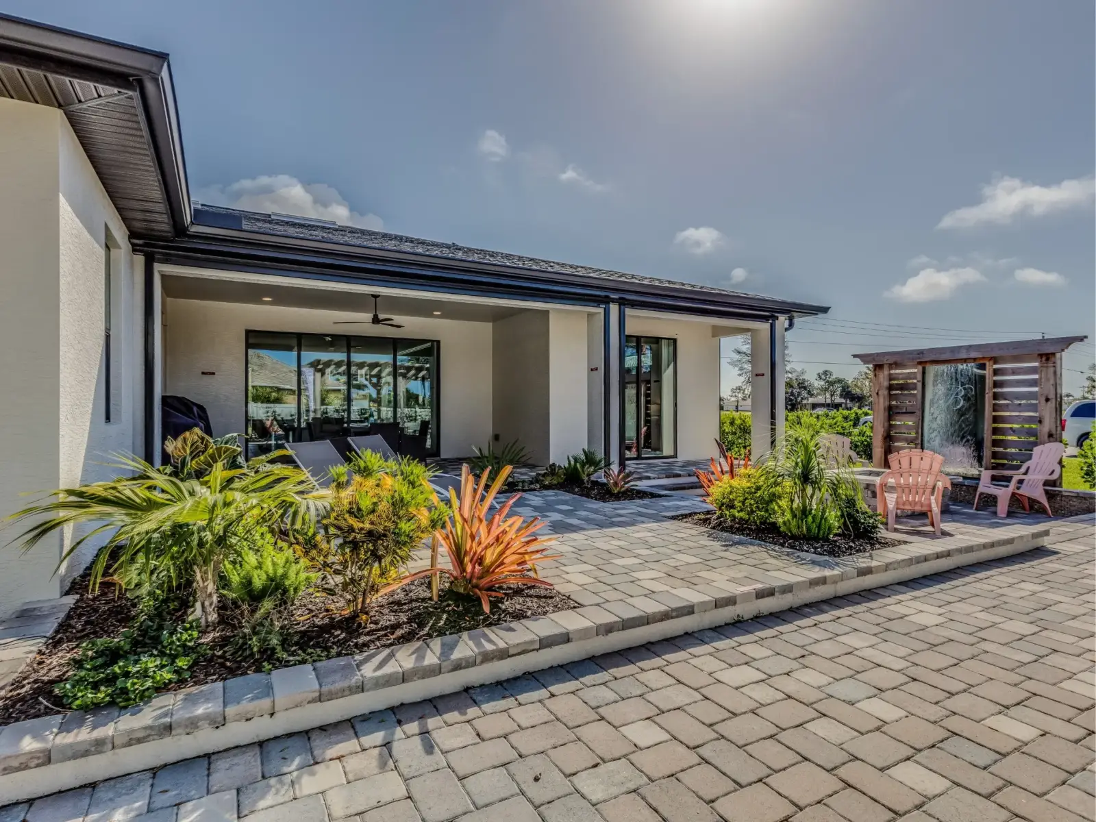 Front walkway with garden beds beside a modern house